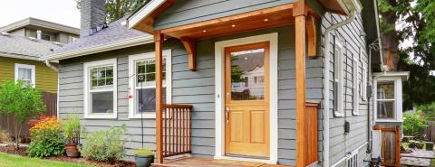 Front entrance of a carriage house with wood features