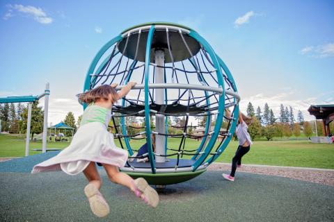 Children playing on playground equipment at park